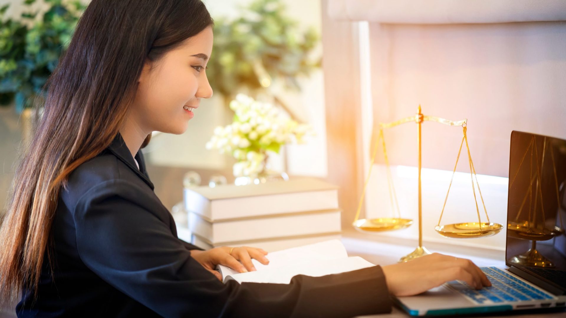 Young,Lawyer,Woman,Work,On,Laptop,With,Scale,Of,Justice